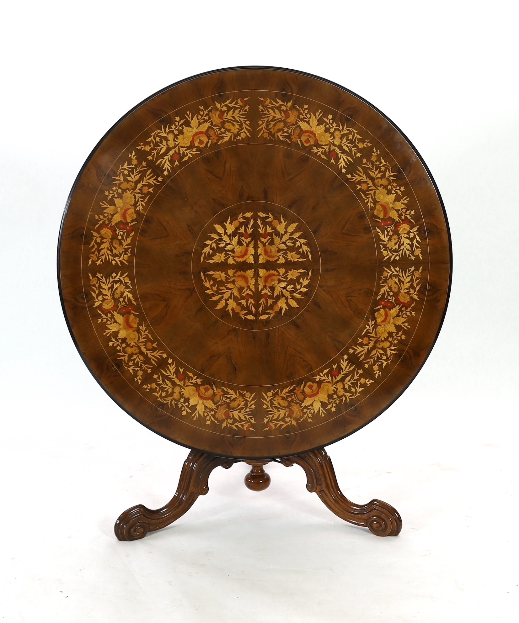 A Victorian-style walnut and marquetry breakfast table Diameter 129 cm. Height 80 cm.